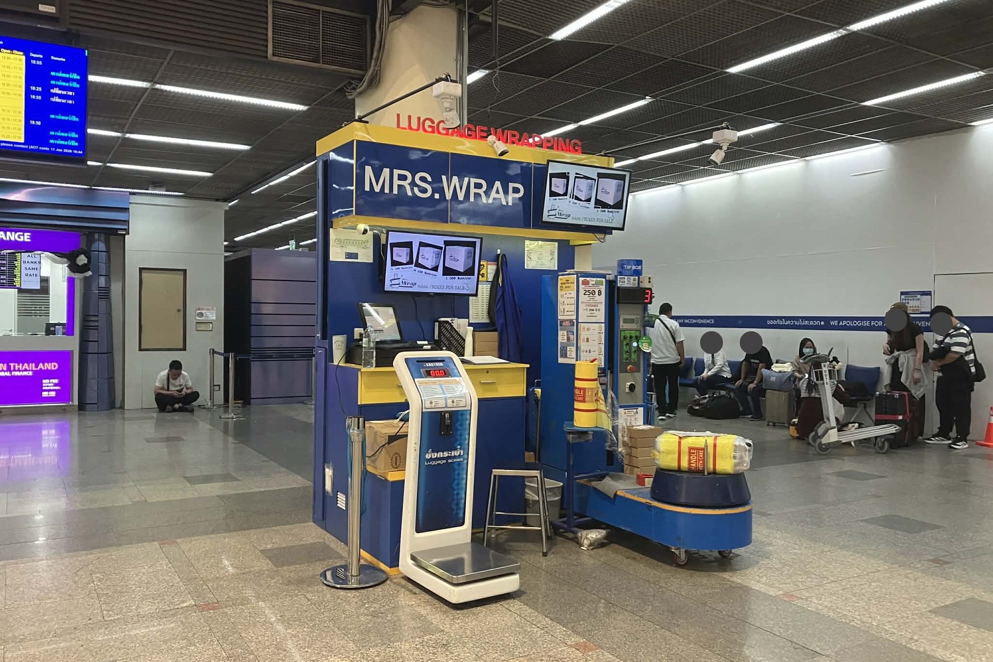 Luggage wrapping service at Don Mueang Airport T1 departure hall