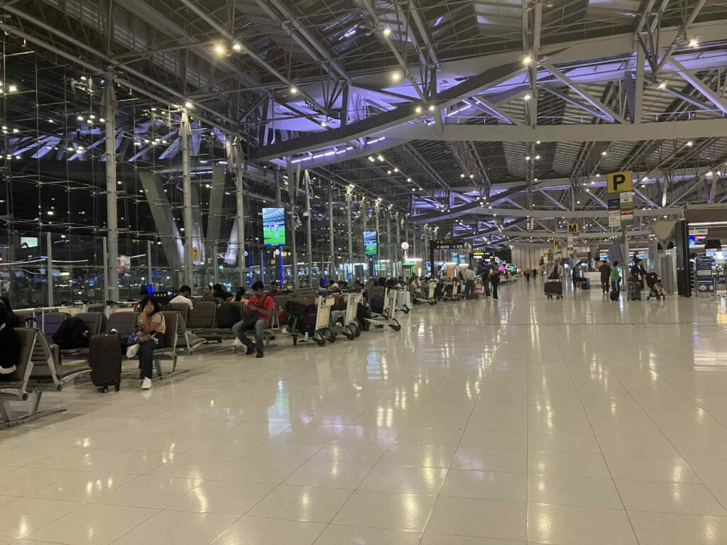 Seating area at Suvarnabhumi Airport 4F with passengers waiting at night