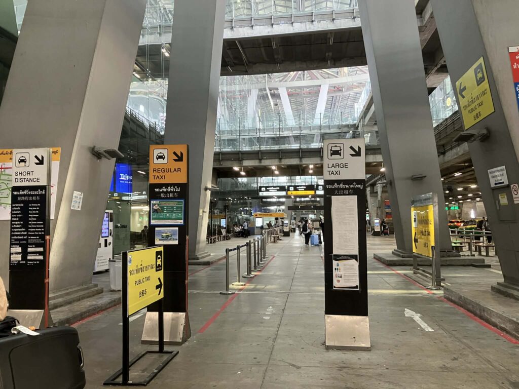 Taxi stand entrance signage at Suvarnabhumi Airport level 1.