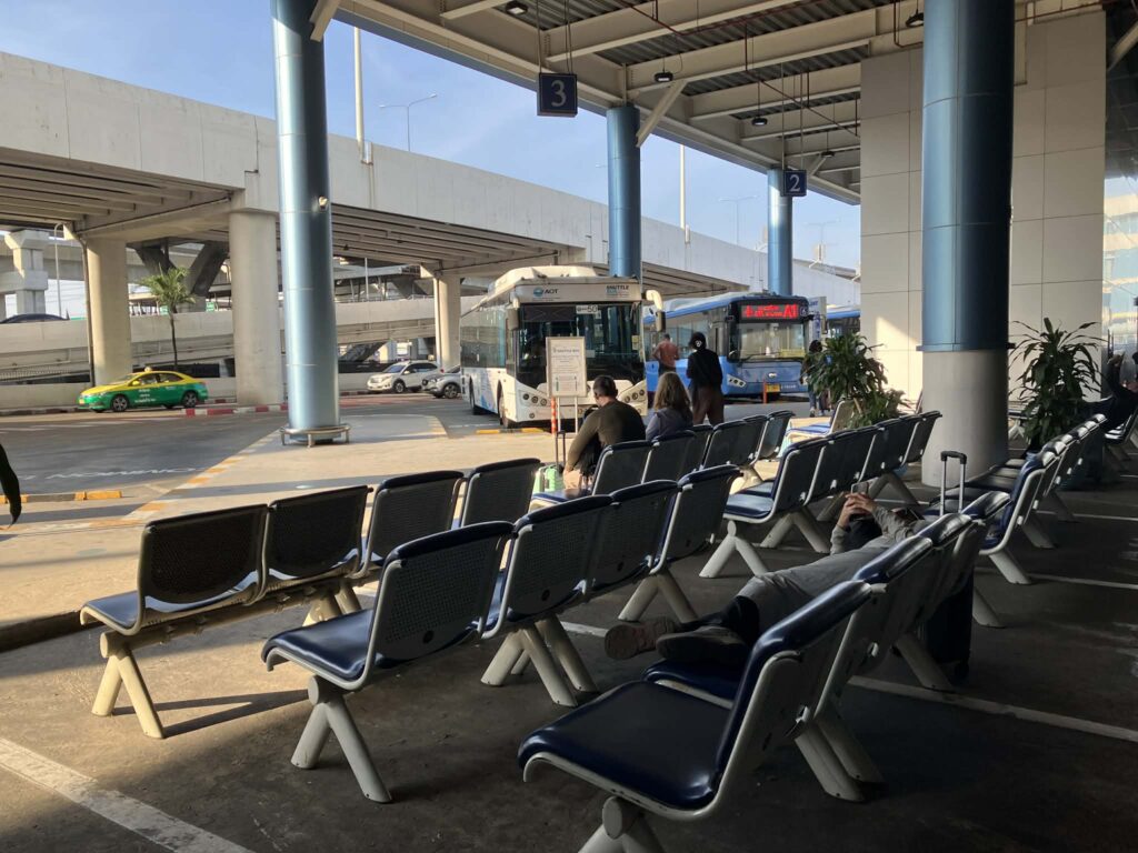 Bus stop seating area outside Don Mueang Airport terminal
