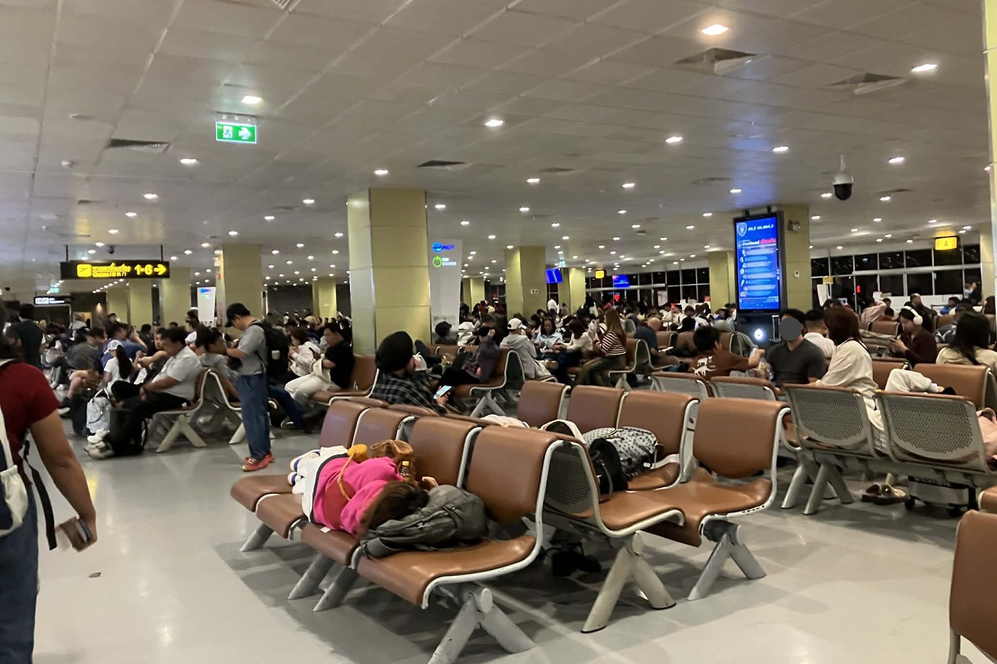 don mueang airport airside seating area crowded night