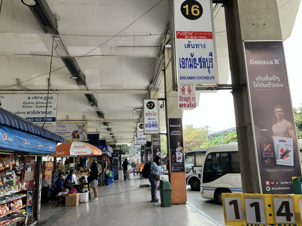 Platform area at Ekkamai Bus Terminal with shops and bus bays