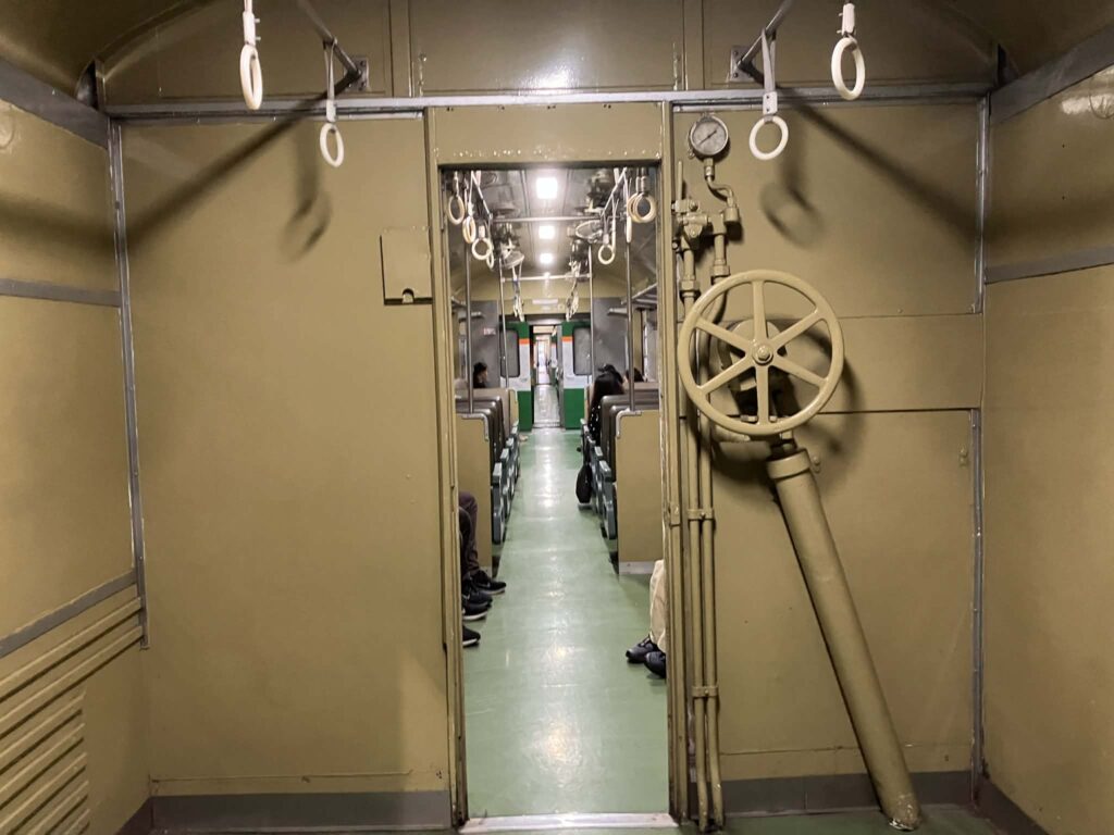 Interior doorway and aisle inside a third-class Thai train carriage