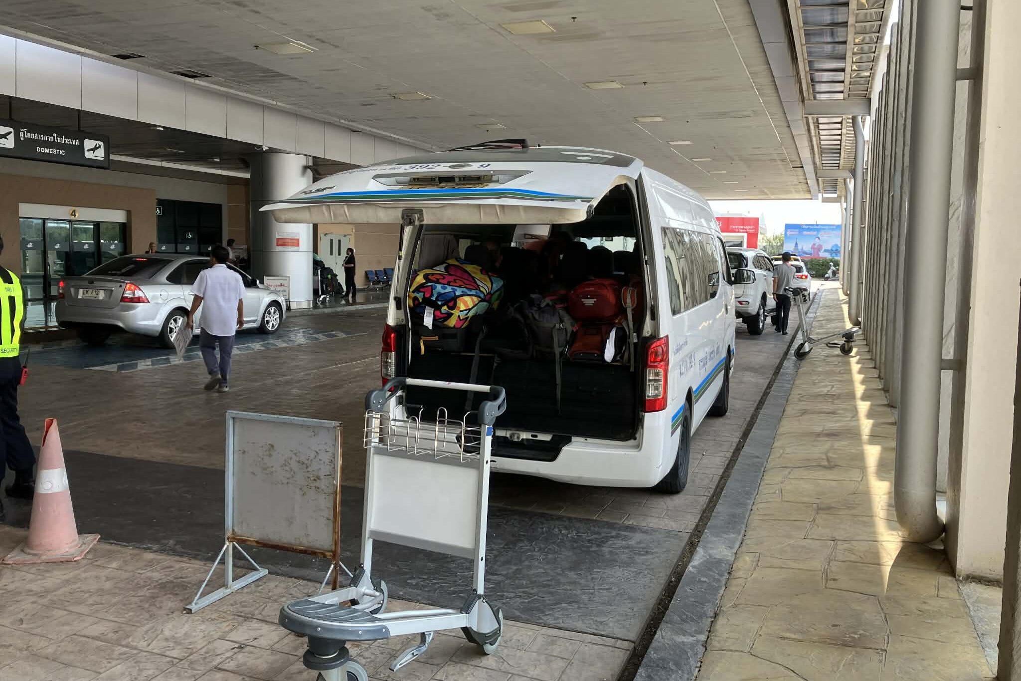 Luggage being loaded into a shared van at U-Tapao Airport